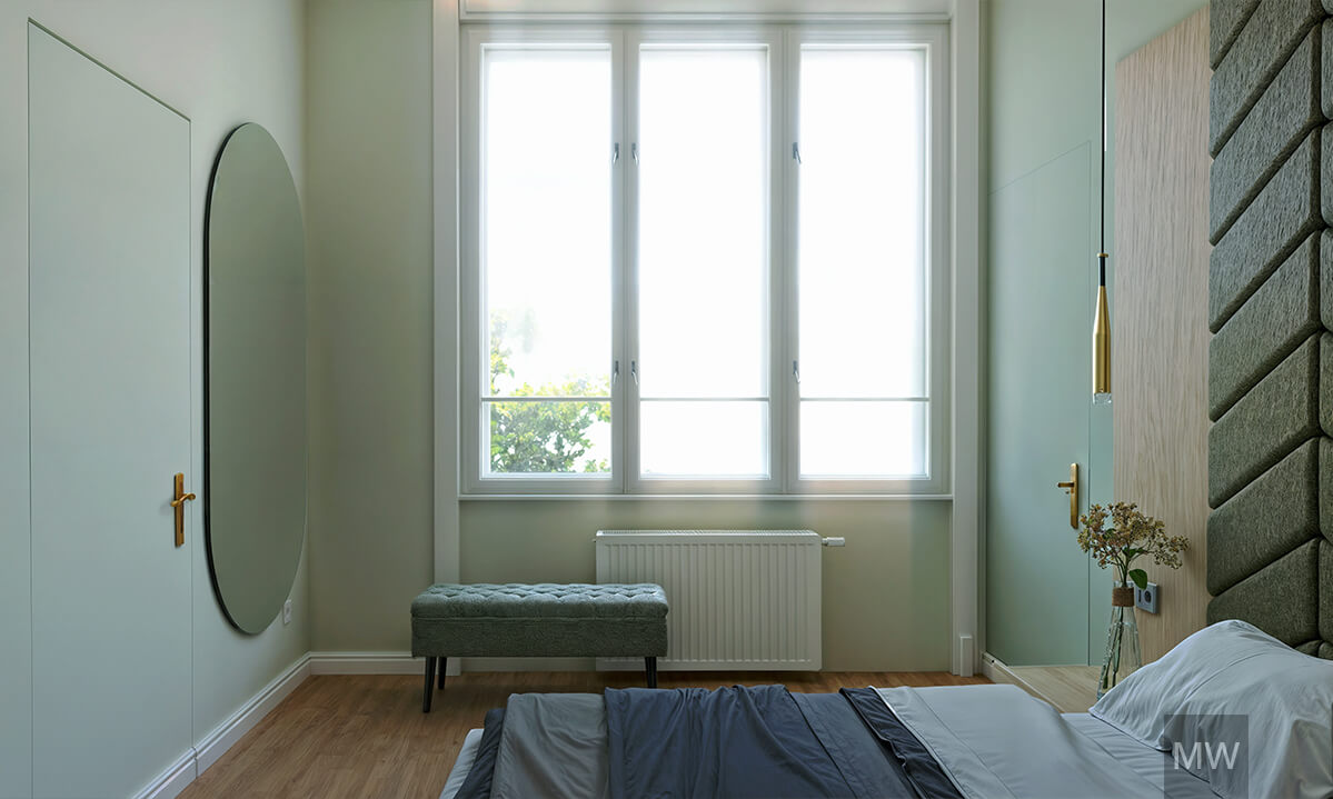 Sophisticated Bedroom Design with Mint Green Walls and Elegant Furnishings | Most Wanted Design Cluj Contemporary bedroom with oval mirror, gold handle, large window, green tufted bench, wooden nightstand, vase with dried flowers, and mint green walls.