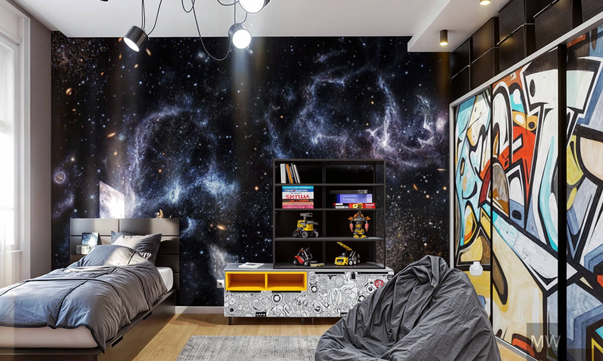Vibrant Cosmic-Themed Bedroom Design with Starry Mural and Graffiti Partition | Most Wanted Design Cluj Contemporary bedroom with starry wall mural, gray bean bag chair, bed with gray bedding, wooden nightstand, graffiti-style partition, and shelf with books.