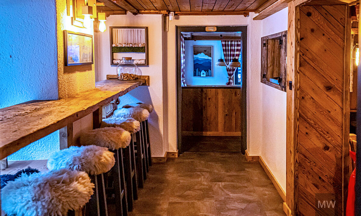 Pensiune rustică cu bar din lemn și atmosferă primitoare Pensiune și restaurant cu decor rustic, bar din lemn și scaune albe pufoase.