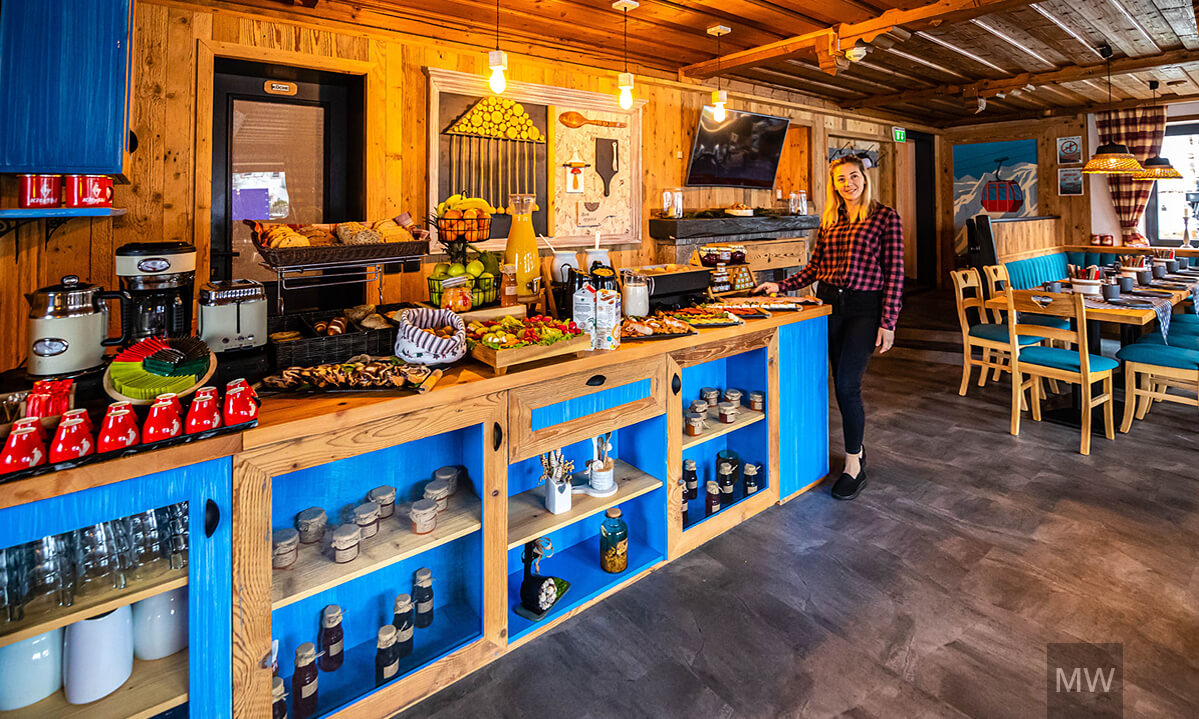 Interior restaurant rustic cu beam-uri din lemn și bufet albastru. Restaurant rustic cu mese din lemn și bufet albastru.