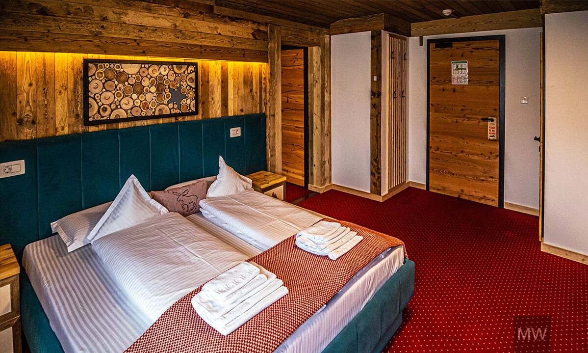 Cameră rustică de dormit cu elemente din lemn. austria, kitzbuchel alpen pension Cameră rustică cu elemente din lemn și pat confortabil. kitzbuchel alpen pension