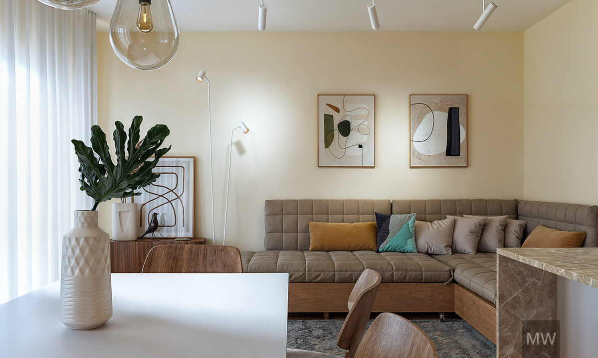 Modern Living Room with Neutral Tones and Abstract Art airbnb apartment Modern living room with a gray sectional sofa, abstract artworks, a wooden dining table, and natural light streaming through a large window. airbnb apartment