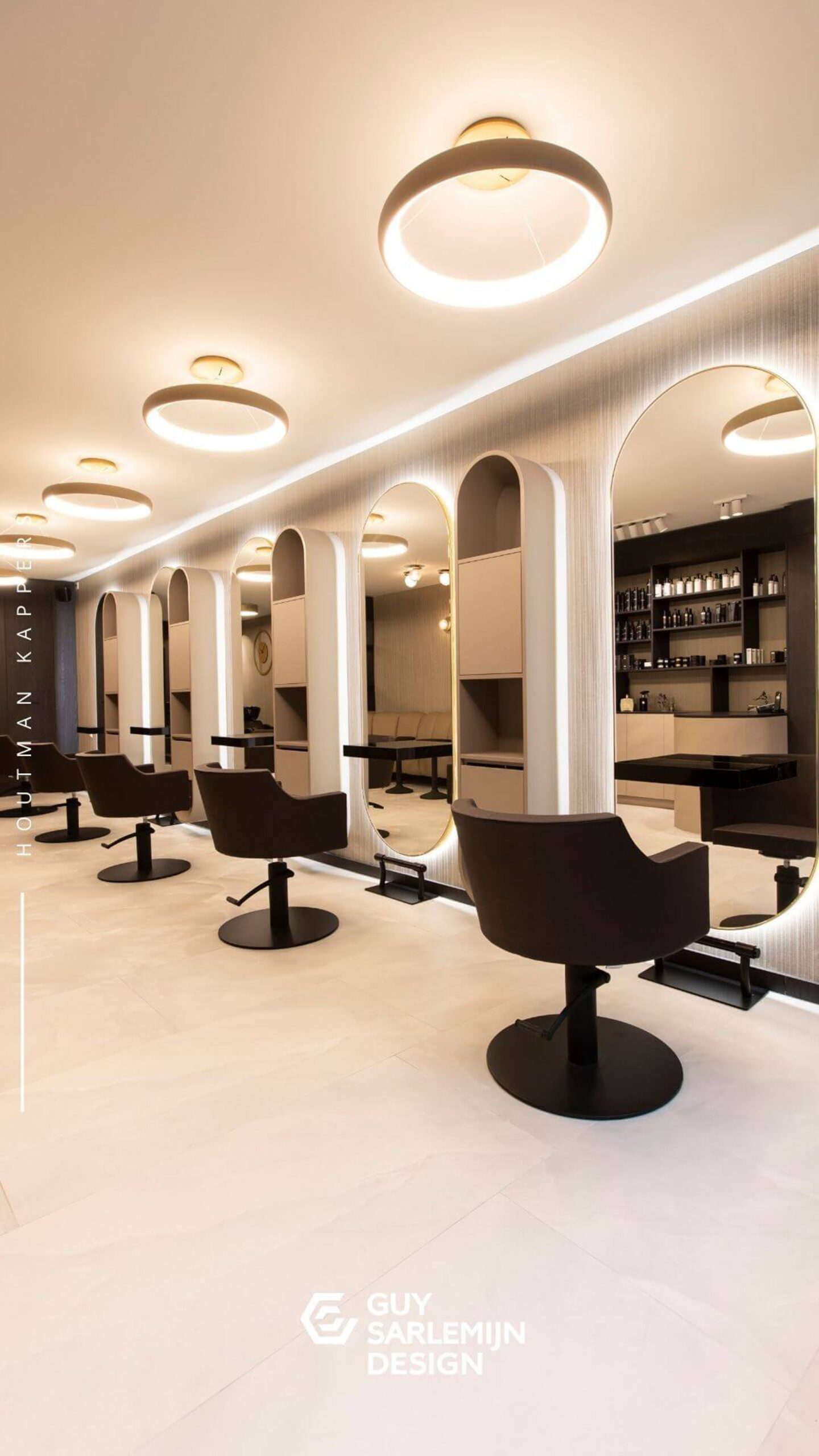 Modern Hair Salon Interior with Warm, Elegant Lighting Modern hair salon with black styling chairs, large elegant mirrors, and warm ambient lighting creating a sophisticated atmosphere.