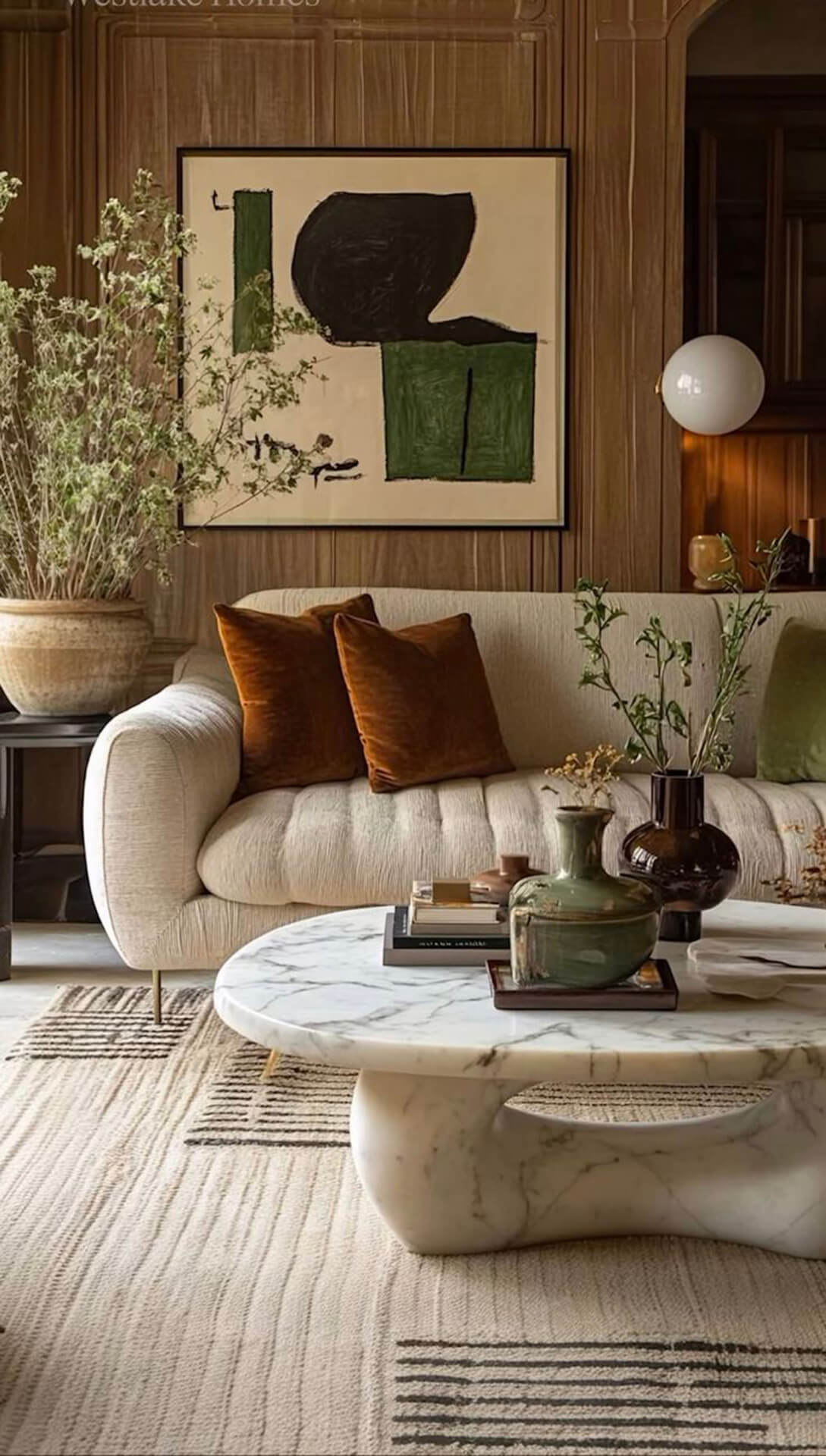 Stylish modern living room with marble coffee table and decorative accents Modern living room with cream sofa, marble coffee table, and abstract artwork