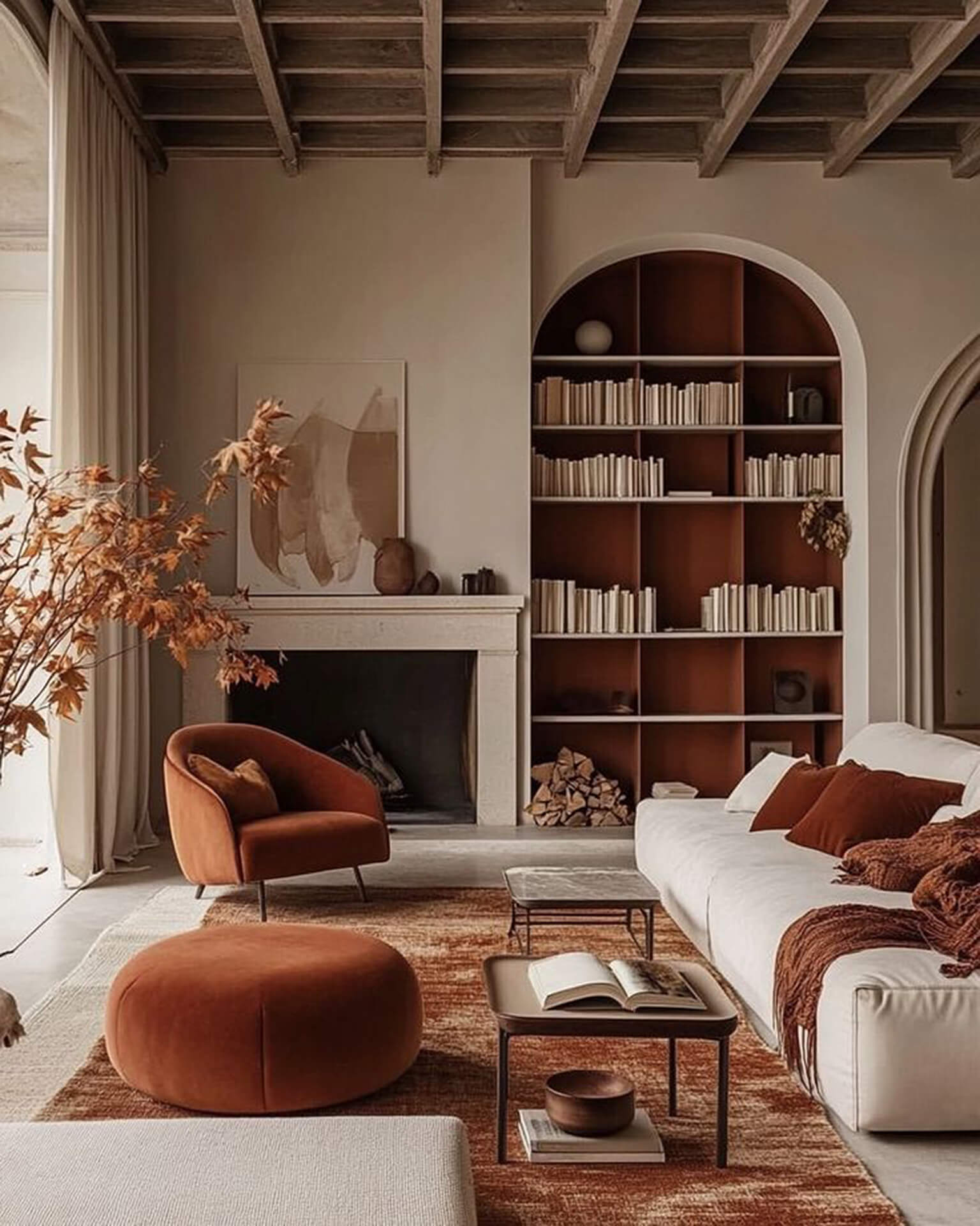 Warm and inviting rustic living room with autumn accents Cozy living room with rustic ceiling, arched bookshelf, and fireplace