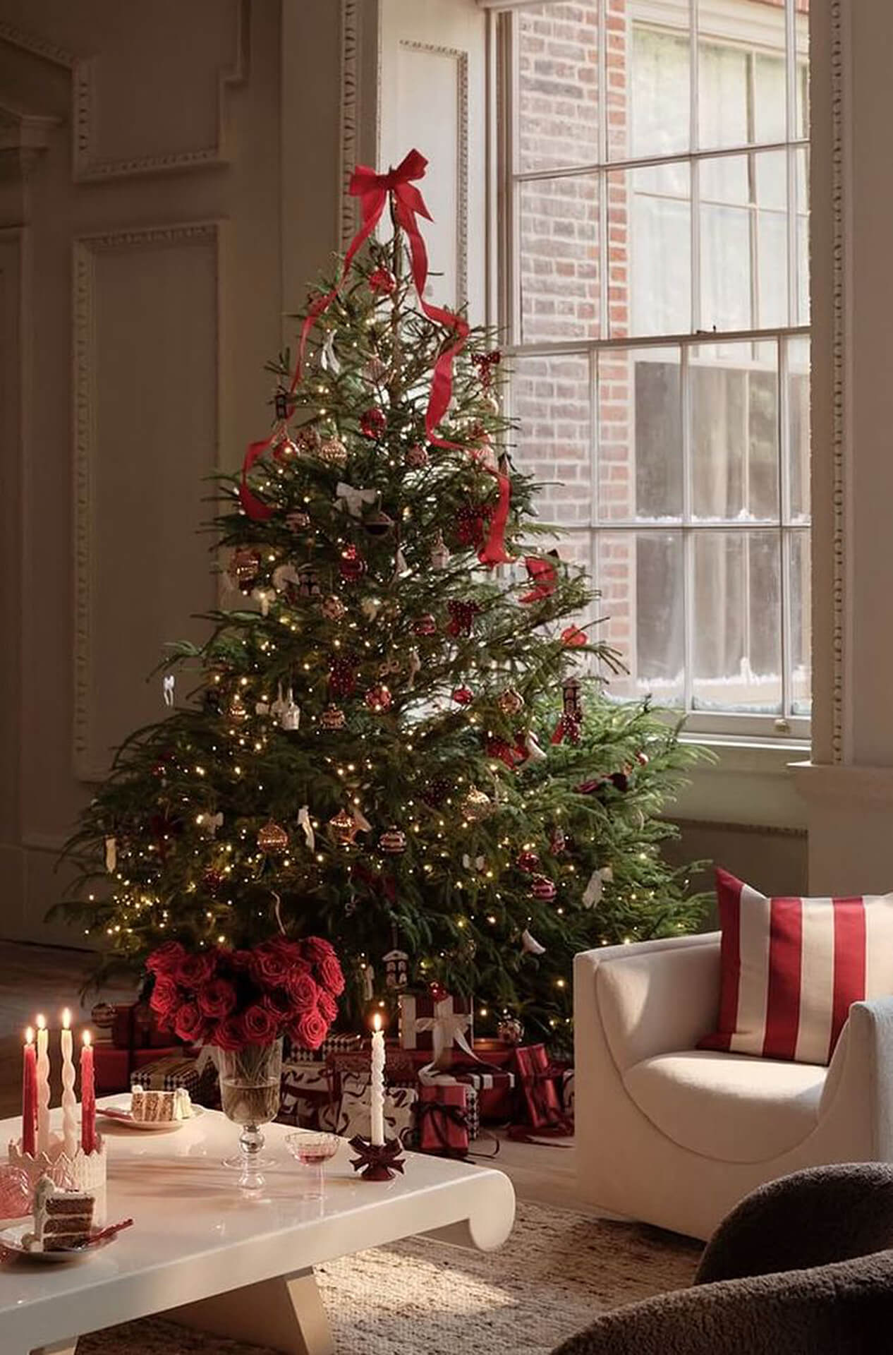 Cozy Christmas Living Room with Festive Decor Cozy living room with decorated Christmas tree, festive pillows, candles, and red accents
