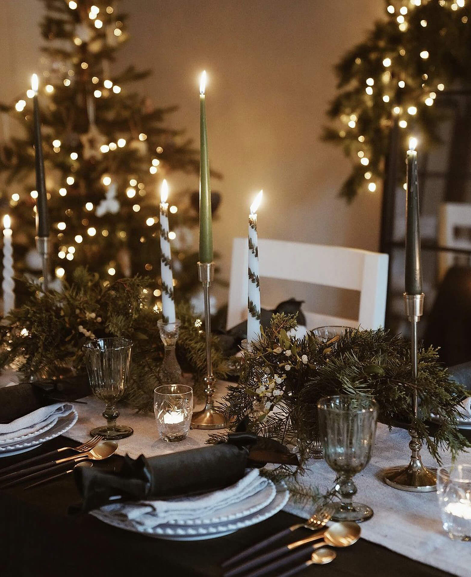 Elegant Christmas Table Setting Christmas table with lit candles and festive decorations