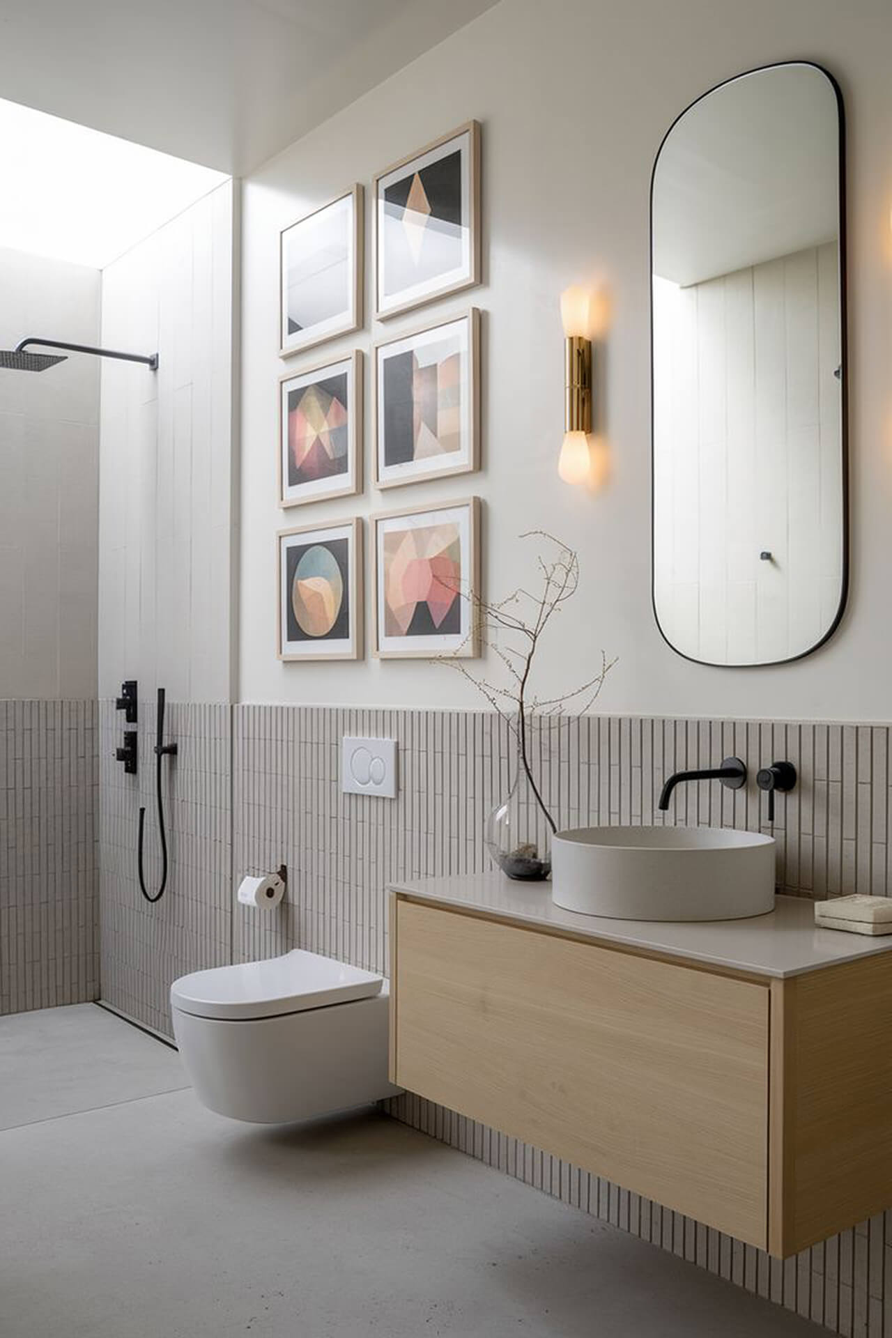 Minimalist Modern Bathroom with Wooden Vanity and Floating Toilet Modern bathroom with light wooden vanity, round sink, wall mirror, and floating toilet